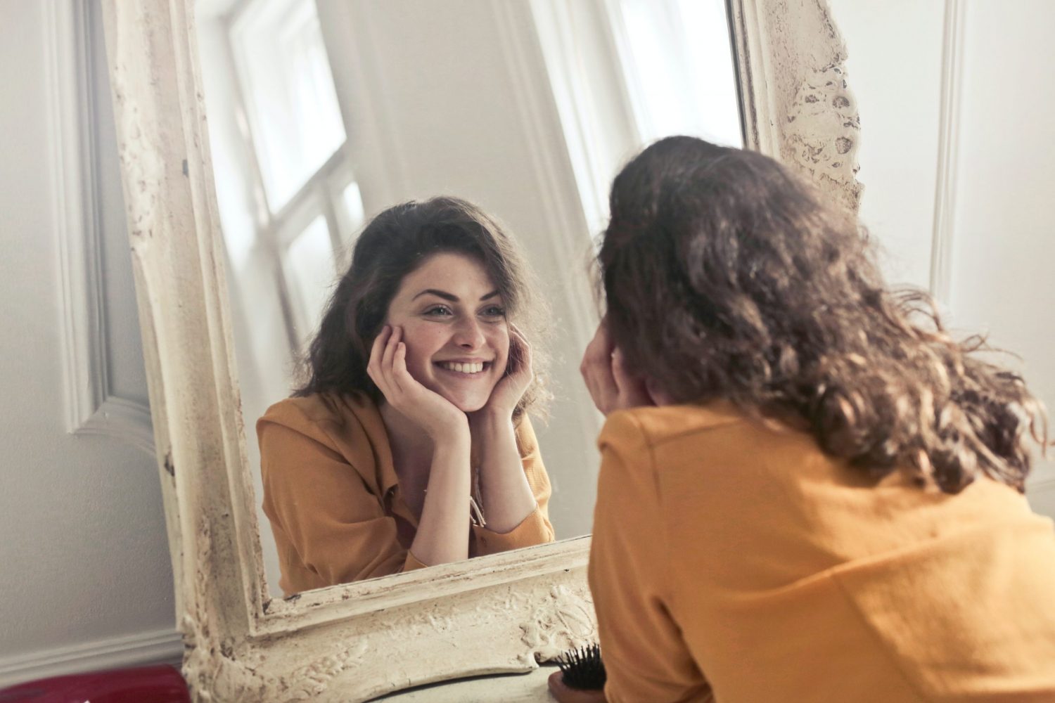 Woman looking at herself and smiling